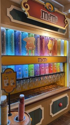 there are many different items on display in the store's front window, including candy bars