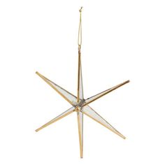 a metal and glass star ornament hanging from a string on a white background