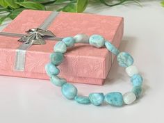 "Discounts: Buy 2 or more items, receive 20% Off. Buy 4 or more Items, receive 25% Off - This beautiful larimar stretch bracelet is made with authentic, high-quality DOMINICAN REPUBLIC larimar tumbler stones ranging in size from Large 12mm - 14mm and threaded with high-quality stretch cord so it easily rolls over your hand and wrist.   Natural Dominican Larimar is beautifully imperfect with each stone having its own unique variations in colors. Note: Please be aware that due to the natural variations in gemstone color and patterns, the bracelet you receive may have slight differences from the one pictured, ensuring its unique character.  Please See ALL Item Photos & VIDEO and Read Full Item Description Before Purchasing.  PRODUCT DETAILS ➤ Gemstone:  Dominican Larimar ➤ Bead Size(s):   12- Crystal Bracelet With Stones As A Gift, Adjustable Amazonite Crystal Bracelet Gift, Larimar Bracelet Jewelry Gift, Amazonite Hand-strung Bracelet As A Gift, Larimar Round Beads Jewelry For Gifts, Larimar Beaded Jewelry For Gifts, Larimar Beaded Jewelry Gift, Larimar Bead Jewelry For Gifts, Turquoise Larimar Bracelets For Gifts