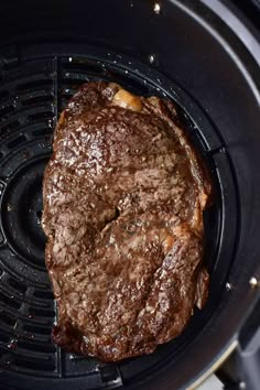 a steak is being cooked in an air fryer