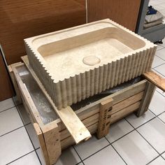 an unfinished sink in the middle of a tiled floor