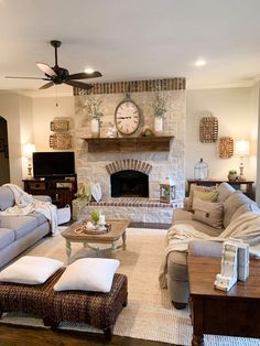 a living room filled with furniture and a clock on the wall above the fire place