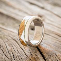 a wedding ring with wood and silver inlays