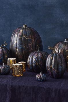 a table topped with lots of different types of pumpkins