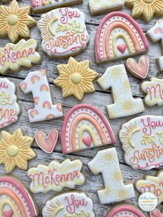 decorated cookies with the words you are my sunshine and rainbows on them in pastel colors