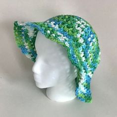 "Here is a crocheted green and blue Blooming Sun Hat.  Made with variegated shades of green, blue and white cotton yarn. This lovely crocheted woman's hat will add a splash of green to your outfit.  It measures 15\" across the brim and 9\" tall.  Lightweight and easy to wear. Makes a great gift. Machine washable and tumble dry low heat." Handmade Bohemian Green Sun Hat, Handmade Green Bohemian Sun Hat, Green Crochet Hat For Beach In Spring, Blue Yarn Sun Hat For Summer, Green Bohemian Crochet Hat For Vacation, Blue Yarn Hats For Vacation, Green Knitted Crochet Hat For Summer, Blue Crochet Yarn Hat For Vacation, Bohemian Handmade Green Sun Hat