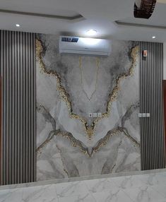 a room with marble walls and flooring in the middle, there is an air conditioner on the wall