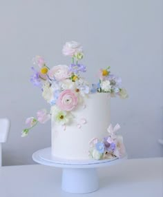 there is a white cake with flowers on it