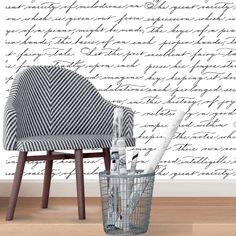 a chair and pen holder in front of a wall with words written on the walls