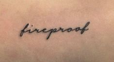 the word fireproof written in cursive writing on someone's back shoulder