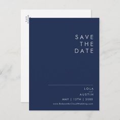 save the date card with white text on a dark blue background and marble textured paper