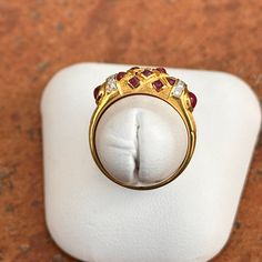 Estate/ vintage 18KT yellow gold Etruscan/ Byzantine design band ring with genuine cabochon red ruby and diamond gemstones. Size: 6.5 Measures: 6.5mm wide 10 Tiny Diamonds .005 carat Weight: 3.90 Grams Stamped 18K Vibrant gold color, almost looks like 22KT Excellent condition Luxury Ruby Ring With Cabochon Cut, Luxury Ruby Cabochon Diamond Ring, Luxury Cabochon Ruby Ring For Anniversary, Yellow Gold Cabochon Ruby Ring, Fine Jewelry Ruby Cabochon Ring, Fine Jewelry Cabochon Ruby Ring In Yellow Gold, Fine Jewelry Ruby Ring In Yellow Gold With Cabochon, Formal Ruby Ring With Diamond And Oval Cabochon Shape, Cabochon Ruby Ring In Yellow Gold