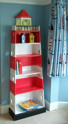 a red and white bookshelf in a child's room with blue walls