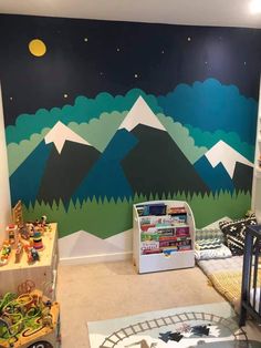 a child's room with mountains painted on the wall