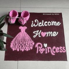 a welcome mat with pink shoes and baby booties on it that says, welcome home to princess