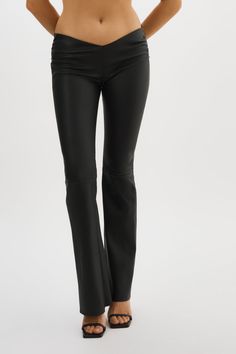 An elevated version of the classic leather trouser, the NADDA low rise leather pants feature a dipped front, ruching at the hips and a flared hem to flatter your shape. Think of them as an effortless foundation for so many outfits. Elegant Flare Leather Pants, Elegant Flared Leather Pants, Sleek Straight Leg Leather Pants For Evening, Leather Trousers For Evening, Fitted Flare Leather Pants For Work, Chic Flared Leather Pants, Chic Flare Leather Pants, Sleek Leather Evening Bottoms, Elegant Flare Leather Pants For Fall