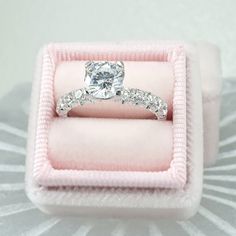 an engagement ring in a pink velvet box