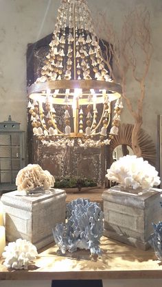 a chandelier and some vases on a table