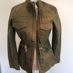 Olive Green With Slight Shadow Striping In Fabric. 4 Front Pockets With Gold Zipper Down Front And Cinch Waist. Great Condition, Never Worn Casual Green Layering Outerwear, Casual Green Outerwear For Layering, Casual Olive Outerwear For Layering, Casual Khaki Outerwear For Layering, Olive Green Utility Jacket, Green Utility Jacket, Stand Up Collar, Gold Zipper, Utility Jacket