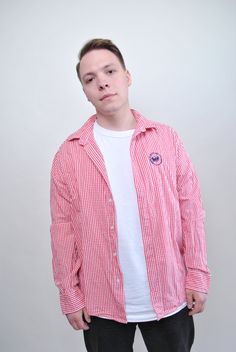 Elevate your casual wardrobe with this 90s pink plaid shirt from TARASCOMMON.ETSY.COM! This vintage check men button-up is a stylish and versatile addition to your collection, perfect for adding a pop of color to your outfit. Crafted from cotton, this 1990s vintage long sleeve shirt offers a comfortable fit that's perfect for everyday wear. The pink plaid pattern adds a fun and playful touch, while the button-up design adds a classic element. Please note that this item is vintage, so it may have Plaid Cotton Preppy Shirt, Preppy Plaid Cotton Shirt, Casual Gingham Cotton Flannel Shirt, Casual Pink Button-up Flannel Shirt, Preppy Plaid Long Sleeve Shirt, Preppy Long Sleeve Plaid Shirt, Casual Gingham Flannel Long Sleeve Shirt, Casual Long Sleeve Gingham Flannel Shirt, Pink Cotton Flannel Long Sleeve Shirt