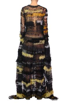 https://shoprodarte.com/pages/made-to-order This hand knit gown features a black knit bateau neckline atop a fitted bodice that flares from the hip into a softly undulating floor skimming skirt.  The open stitchwork knitted in a mohair/alpaca/silk yarn blend with embedded sequins creates an intriguing abstract pattern of black, silver, gold and yellow.  Dramatic floor length asymmetric bell sleeves with metallic silver knit edging complete the look. This style fits true to size, we suggest taking your normal size Model wears size XS/S Composition: 37% Superkid Mohair, 15% Alpaca, 15% Silk, 10% Cotton, 6% Nylon, 6% Wool, 5% Metallic Polyester, 3% Viscose,3% Rayon Hand knit Do not hang Hand spot lean only with wool cleaner and towel dry Made in the USA Noro Knitting, Goth Chic, Knit Gown, Handmade Yarn, Knit Edge, Gown Black, Fashion Design Portfolio, Bateau Neckline, Silk Yarn