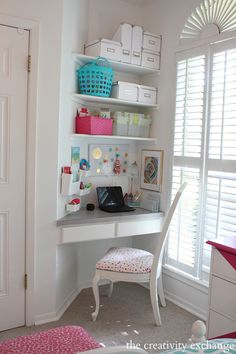 a white desk with a laptop on top of it in a bedroom next to a window