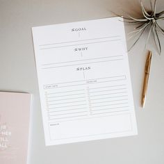 a notepad and pen sitting on top of a table