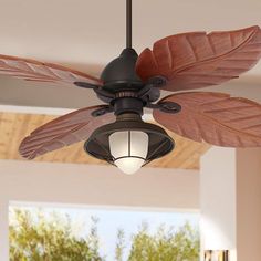 a ceiling fan with two large leaves on the blades and a light bulb attached to it