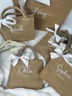 three personalized burlock bags with white ribbons