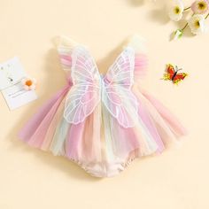 Dress your little angel in whimsy and color with our Baby Butterfly Wing Romper Dress. Designed for infant girls, this romper dress combines the comfort of a romper with the charm of a summer dress. Featuring exquisite embroidery of butterfly wings, fly sleeves, and a rainbow-colored tulle skirt, this outfit is a dream come true for summer days. The highlight of this romper dress is the beautifully embroidered butterfly wings on the back, adding a magical touch to your baby girl's outfit. Delica Girls Party Wear, Rainbow Fairies, Capes For Kids, Beautiful Fairy, Dress Embroidery, Colour Ways, Birthday Special, Infant Girl, Floral Print Rompers