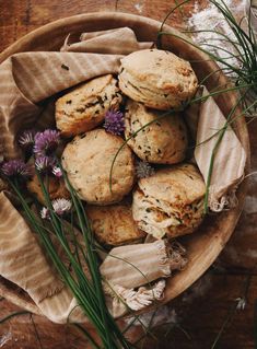 some biscuits and flowers in a wooden bowl