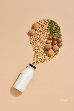 a milk bottle with nuts and seeds in the shape of a human's head