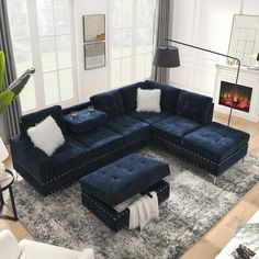 a large blue sectional couch sitting on top of a rug