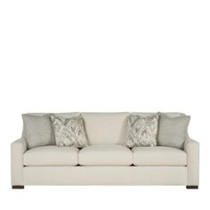 a white couch with two pillows on it's back and one arm facing the camera