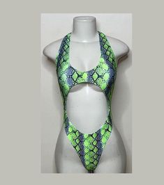 Welcome to my shop Let's Make Money Together 💕 DETAILS  * Handmade Item  * Materials: Nylon, Spandex * Front Cut-Out Bodysuit  * Never used  DESCRIPTION  * Thong Bodysuit  * Neon Green Snake Print Spandex * 4 way stretch Fabric  * Mannequin is wearing XS/Small (may choose sizing at checkout)  SHIPPING  My current shipping turnaround is really quick 1 to 2 days  RETURNS & EXCHANGES  No refunds or exchanges if you have any issues with your purchase please feel free to reach me personally. I can a Summer Rave Festival Leotard, Summer Festival Rave Leotard, Summer Festival Rave Style Leotard, Green Club Bodysuit, Summer Festival Dancewear Bodysuit, Green Rave Bodysuit For Party, Green Stretch Rave Bodysuit, Green One-piece Bodysuit For Club, Green One-piece Club Bodysuit