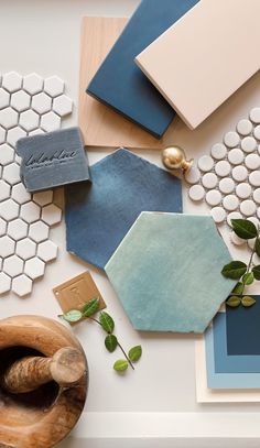 the table is covered with different types of tile and wood pieces, including hexagonal tiles