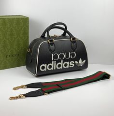 Part of the adidas x Gucci collection, this mini duffle bag features the 'Gucci adidas' and Trefoil print. adidas and Gucci venture into a collection, where the Web juxtaposes with the three white stripes, and the GG monogram combines with the trefoil. Pulling inspiration from the Creative Director’s memories of the '80s and '90s, emblematic House’s motifs mix with those of the historic sportswear brand adidas resulting in a series of hybrid looks.es. Adidas X Gucci, Gucci X Adidas, Gucci Collection, Mini Duffle Bag, Gg Monogram, Adidas X, Handbag Wallet, Sportswear Brand, Timeless Handbag