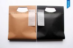 two brown and black bags with price tags on the top one has a paper tag attached to it