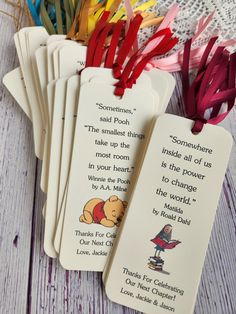 several winnie the pooh bookmarks are laying next to each other on a table