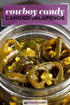 a jar filled with green peppers and corn next to a purple sign that says cowboy candy candied jalapenos