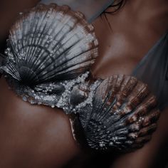 two seashells are laying on the back of a woman's stomach,