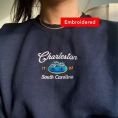 "*SIZES ARE UNISEX* -I'd suggest your usual size for a more fitted look, or sizing up for a more relaxed fit. *these sweatshirts are extra comfy when oversized \"Charleston South Carolina 1783\" embroidered on a cute vintage-style crewneck. A cozy sweatshirt bound to keep you warm in the colder months. A pre-shrunk, classic fit sweater that's made with air-jet spun yarn for a soft feel and reduced pilling. Your new favorite sweatshirt! * 50% cotton, 50% polyester * Pre-shrunk * Classic fit with no center crease * 1x1 athletic rib knit collar with spandex * Air-jet spun yarn with a soft feel and reduced pilling * Double-needle stitched collar, shoulders, armholes, cuffs, and hem * Gildan 18000 Unisex Heavyblend Sweatshirt Please note that the embroidery comes with a backing that acts as a s South Carolina Sweatshirt, Casual Tops With Custom Embroidery For College, Relaxed Fit Crew Neck Sweatshirt With Embroidered Text, Relaxed Fit Sweatshirt With Embroidered Text, Custom Embroidery Crew T-shirt For College, Crew Neck T-shirt With Custom Embroidery, Custom Embroidered Crew T-shirt For College, College Crew T-shirt With Custom Embroidery, Fitted Casual T-shirt With Custom Embroidery