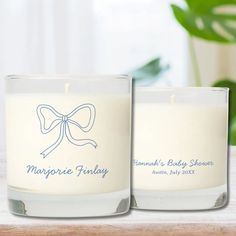 two personalized candles are sitting on a table