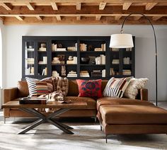 a living room filled with lots of furniture and bookshelves on top of each other