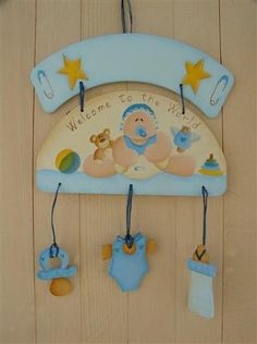 a baby's mobile hanging on the wall with its name written welcome to the world