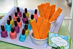 there is a tray with corn on the cob and nail polishes in it