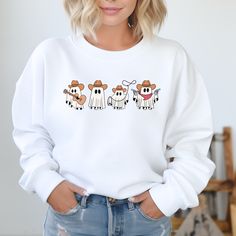 Stay cozy and stylish in our Cowboy Ghosts Sweatshirt. This western-inspired sweater features cute ghost designs that will add a playful touch to your wardrobe. Get ready to turn heads and keep warm in our unique and fun sweatshirt. White Cartoon Print Sweater For Fall, White Sweatshirt With Character Print For Fall, White Fun Sweater For Fall, Fun White Sweater For Fall, White Cartoon Print Sweatshirt For Fall, Fall Character Print Relaxed Fit Sweatshirt, Ghost Design, Fun Sweatshirts, Cute Ghost