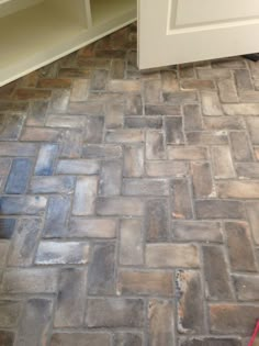 a kitchen floor that has some kind of tile on it