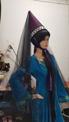 The elegant style has a beautiful tail of 1m in length of black netting, finished with purple tassels.  Only 2 pieces available: 1 X Medium - 55 - 57cm   1 X Large - 58 - 60cm The design is great for Medieval Fares, Theatre Costuming, Medieval Weddings, Cosplay, Fancy dress parties etc.  Handcrafted by myself in The Hat Room, the hat is sturdily constructed with a 3 ply outer body - cardboard, craft foam and fabric/braid - then generously glued together using only the highest quality contact and Medieval Headdress, Medieval Headwear, Medieval Halloween, Medieval Hats, Medieval Gothic, Medieval Wedding, Medieval Costume, Fancy Dresses Party, Black Veil