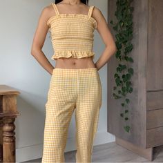 Callipygian Yellow Gingham Ruffle Shirred Crop Top & Pants Two Piece Set The Cutest Set! The Fabric Is Not Just A Plain Flat Yellow Gingham Print, It Has Some Crinkle Details Throughout Which Makes Is Sooo Cute And Refined Top Is Xs, Has Elasticized Shirred Panel All Around So It Hugs Your Body Super Well And Has Lots Of Stretch; Pants Are A Size 2, It’s Not My Size So It’s A Bit Loose On Me, Shown On A 23” Waist; Measurements Waist: 14 Inch Flat Across, Fits Low Waist Inseam: 24 1/2 Inch Bought Fitted Gingham Cotton Sets, Fitted Yellow Playful Sets, Cute Fitted Gingham Sets, Gingham Two Piece, Yellow Gingham Top, Shirred Crop Top, Bell Bottoms Outfit, Yellow Gingham, Yellow Plaid